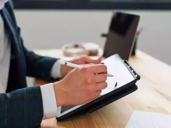 Man doing signature digitally on tablet using Monkey Solar Custom Solar CRM Software